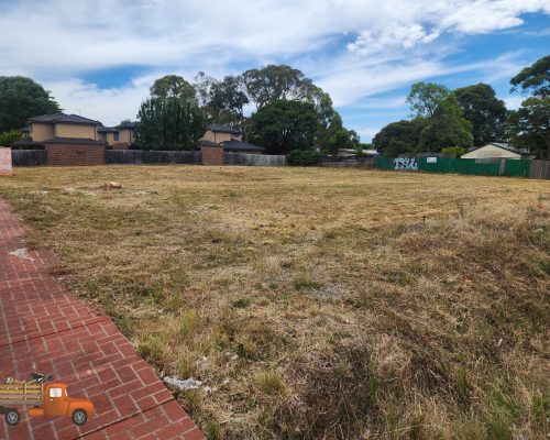 Vacant block in suburb Heathmont after professional ride-on mowing service showing neatly cut grass
